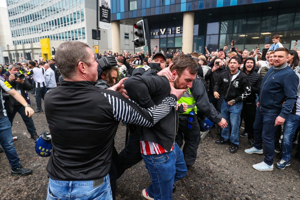 Newcastle and Sunderland fans fight in the street and throw bottles in violent clashes